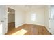 Hardwood floor bedroom with an open door to another room at 407 Somers Ave, Burlington, NC 27215