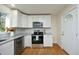 Bright kitchen with white cabinets, granite counters, and stainless steel appliances at 407 Somers Ave, Burlington, NC 27215