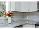 Modern kitchen with white cabinets and hexagon tile backsplash at 407 Somers Ave, Burlington, NC 27215