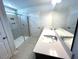 Bright bathroom featuring a tiled shower, a white counter and double sinks at 45 Calabria Ct, Franklinton, NC 27525