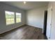 Neutral bedroom with hardwood floors and view of the outside through the windows at 45 Calabria Ct, Franklinton, NC 27525