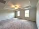 Large bedroom with neutral walls, two windows, and a ceiling fan for ample lighting and ventilation at 45 Calabria Ct, Franklinton, NC 27525