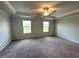 Spacious bedroom featuring plush carpeting, a ceiling fan, and natural light from the windows at 45 Calabria Ct, Franklinton, NC 27525