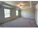 Large bedroom with neutral walls, two windows, and a ceiling fan for ample lighting and ventilation at 45 Calabria Ct, Franklinton, NC 27525