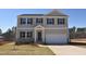 Charming two-story home featuring neutral siding, stone accents, a two-car garage, and a well-manicured front lawn at 45 Calabria Ct, Franklinton, NC 27525