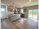 Modern kitchen with island, stainless steel appliances, and sliding door to deck at 45 Calabria Ct, Franklinton, NC 27525