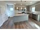Eat in kitchen with center island, stainless appliances, and view to stairs at 45 Calabria Ct, Franklinton, NC 27525