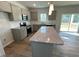 Eat in kitchen with center island, stainless appliances, and view to deck at 45 Calabria Ct, Franklinton, NC 27525