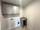 Practical laundry room with upper cabinets, granite countertop, and tile flooring at 45 Calabria Ct, Franklinton, NC 27525