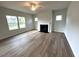 Bright living room featuring a fireplace, hardwood floors and multiple windows at 45 Calabria Ct, Franklinton, NC 27525