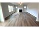 Bright living room with modern fireplace, hardwood floors and multiple windows at 45 Calabria Ct, Franklinton, NC 27525