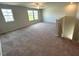 Large living room with carpet flooring, three windows and a ceiling fan at 45 Calabria Ct, Franklinton, NC 27525