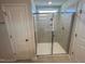 Walk-in shower with a glass door, tiled walls, and built-in shelving at 45 Calabria Ct, Franklinton, NC 27525
