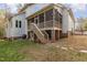 Two-story house with screened porch and deck, nestled in a wooded area at 5040 Darcy Woods Ln, Fuquay Varina, NC 27526