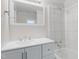 Clean bathroom with white vanity, tiled shower, and mirror at 521 Mill St, Smithfield, NC 27577