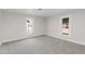Spacious bedroom with gray carpeting and two windows offering natural light at 521 Mill St, Smithfield, NC 27577