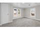 Bright bedroom with neutral walls and carpet, featuring two windows at 521 Mill St, Smithfield, NC 27577