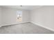 Well-lit bedroom with gray carpeting and a large window at 521 Mill St, Smithfield, NC 27577