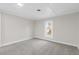 Cozy bedroom with gray carpeting and a window overlooking the yard at 521 Mill St, Smithfield, NC 27577