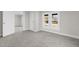 Spacious bedroom with gray carpet, and a view into another room at 521 Mill St, Smithfield, NC 27577