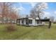 Charming white house with black accents, covered porch, and a well-maintained lawn at 521 Mill St, Smithfield, NC 27577