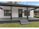 House exterior showcasing a welcoming front porch with gray flooring and black support beams at 521 Mill St, Smithfield, NC 27577