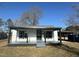 White house with black trim, covered porch, and a small yard at 521 Mill St, Smithfield, NC 27577