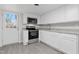 Modern kitchen with white cabinets, stainless steel appliances, and granite countertops at 521 Mill St, Smithfield, NC 27577