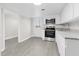 Updated kitchen with white cabinets and stainless steel appliances at 521 Mill St, Smithfield, NC 27577