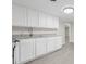 Modern kitchen with white cabinets, granite countertops, and stainless steel appliances at 521 Mill St, Smithfield, NC 27577