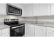 Kitchen featuring white shaker cabinets, granite countertops, and stainless steel appliances at 521 Mill St, Smithfield, NC 27577