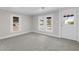 Living room featuring neutral walls, gray carpet, and multiple windows at 521 Mill St, Smithfield, NC 27577