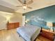 Bedroom with hardwood floors, ceiling fan, and accent wall at 5718 Sentinel Dr, Raleigh, NC 27609