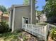 Side of home, featuring neutral siding, a spacious deck and outdoor access at 5718 Sentinel Dr, Raleigh, NC 27609
