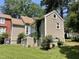 A serene home exterior with tidy siding, lush greenery, and meticulous landscaping at 5718 Sentinel Dr, Raleigh, NC 27609
