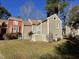 Tan colored house exterior with part of neighboring houses at 5718 Sentinel Dr, Raleigh, NC 27609