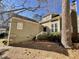 Two-story house with tan siding, landscaping, and a deck at 5718 Sentinel Dr, Raleigh, NC 27609