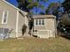 Rear view of house showing back door, steps, and storage unit at 5718 Sentinel Dr, Raleigh, NC 27609