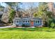 Gray house with orange door and green lawn at 604 Hadley Rd, Raleigh, NC 27610