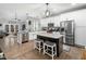 Modern kitchen with white cabinets, granite counters, and stainless steel appliances at 605 Richlands Cliff Dr, Youngsville, NC 27596