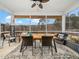 Screened porch with table, chairs, and view of wooded backyard at 605 Richlands Cliff Dr, Youngsville, NC 27596