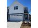 Two-story home with gray and white siding, two-car garage, and landscaping at 620 Brittany Ct, Durham, NC 27703