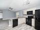 Modern kitchen with granite countertops and black appliances at 801 Thornberry Ct, Spring Hope, NC 27882