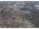 Aerial view of the house and surrounding neighborhood, including a nearby lake at 802 S Sellars Mill Rd, Burlington, NC 27217