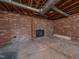 Unfinished basement features a brick fireplace and ample storage space at 802 S Sellars Mill Rd, Burlington, NC 27217