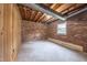 Unfinished basement room with brick walls and wood paneling at 802 S Sellars Mill Rd, Burlington, NC 27217