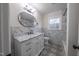 Modern bathroom with white vanity, marble tile, and patterned floor at 802 S Sellars Mill Rd, Burlington, NC 27217