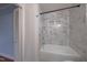 Clean bathroom with a bathtub, shower, and marble tile walls at 802 S Sellars Mill Rd, Burlington, NC 27217