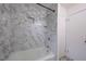 Updated bathroom with a bathtub, shower, and marble tile surround at 802 S Sellars Mill Rd, Burlington, NC 27217
