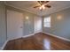 Bright bedroom with hardwood floors, ceiling fan, and closet at 802 S Sellars Mill Rd, Burlington, NC 27217